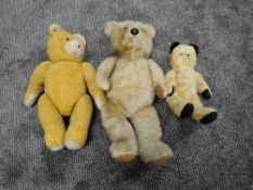 Three mid 20th century straw filled yellow plush Teddy Bears, plastic eyes and nose, stitched