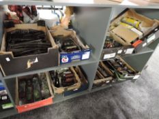 A large collection on four shelves containing nine boxes of 0 gauge including Hornby and similar,