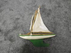 A Star Pond Yacht, named Northern Star in green and white with mast