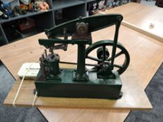 A Stuart Turner Live Steam Beam Engine having spoked flywheel, numbered 80063, on wooden base,