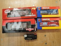 A HO scale 0-4-0 American Locomotive 21 along with four HO scale Atlas and Life Like Trains