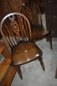 A pair og traditional dark stained wheelback chairs