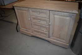 A modern laminate lime oak effect sideboard, on castors, width approx. 128cm