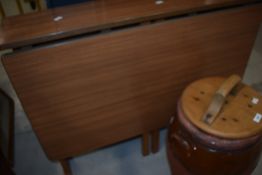 A vintage formica topped drop leaf kitchen table