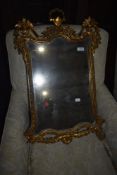 A gilt framed wall mirror