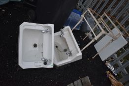 Two porcelain sinks and metal stands