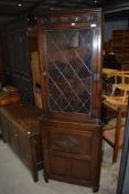 A Priory style corner display with cupboard under