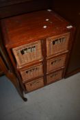A stained frame and wicker storage unit