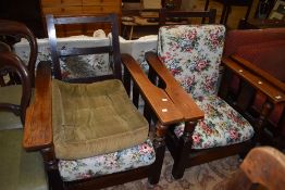 A pair of early 20th Century oak recliner armchairs, on shepherds castors