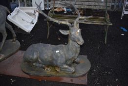 A cast alloy deer, lying