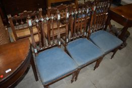 A set of three Victorian salon chairs having blue upholstery and painted detail