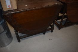 An early 20th Century oak twist gate leg table having chop carved decoration