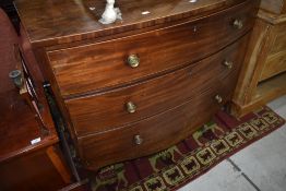 A 19th Century bow fronted chest of three long drawers having satinwood edging, width approx. 110cm