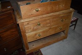 A stripped pine low chest of two over two drawers, width approx. 113cm