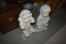 A pair of ornamental plaster figures