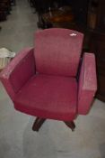 A vintage armchair on swivel base, semi recliner, on metal swivel base in moquette upholstery