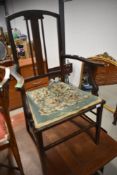 An Edwardian stained frame carver salon chair