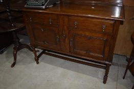 An early 20th Century oak sideboard having twist legs