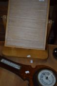 A stripped toilet mirror frame and barometer