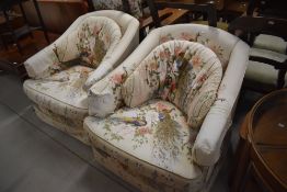 A pair of vintage armchairs, having peacock themed upholstery