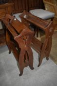Two Arts and Crafts two tier book troughs, both of similar design one in oak the other in mahogany