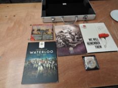 A metal case containing part Medallion Sets, including Battle of Waterloo, In Flanders Field, Battle