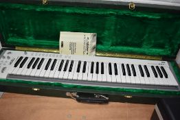 A Korg 61-P midi studio controller keyboard, in plush lined hard case