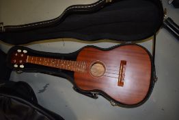 An interesting bass ukulele or acoustic , with henna style decoration to headstock, in fitted case