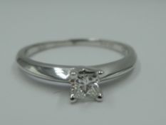 A princess cut diamond solitaire dress ring, approx 0.20ct, in a 4 claw set mount to knife blade
