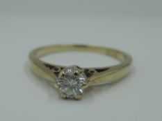 A diamond solitaire dress ring, approx 0.25ct in a raised mount to knife blade shoulders on a 9ct