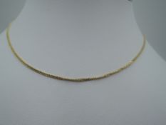 A yellow metal fine curb chain stamped 9Kt, approx 16' & 2.7g