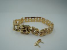 A yellow metal fancy link bracelet stamped 750 having concealed box clasp and double safety