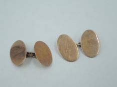 A pair of 9ct rose gold cufflinks of plain oval disc form with chain connectors, approx 5g
