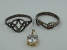 A cubic zirconia solitaire pendant in a 9ct gold mount (no chain) and two white metal dress rings