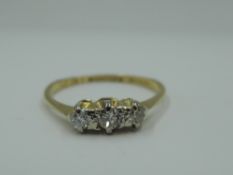 A diamond trilogy ring, approx 0.12ct on a yellow metal loop stamped 18ct & plat, size O & approx