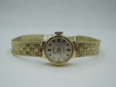 A lady's 14ct gold wrist watch by Anker having baton numeral dial to small circular face in gold