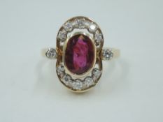 A yellow metal dress ring stamped 14ct having a central oval ruby, approx 1.5ct within a diamond set