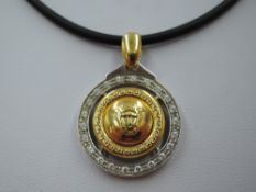 A white and yellow metal Versace Medusa style pendant necklace stamped 750 having the central Medusa