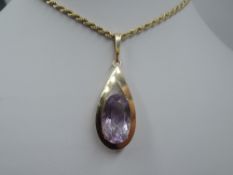 A large amethyst pendant in a yellow metal tear drop shaped open mount stamped 9ct on a 9ct gold