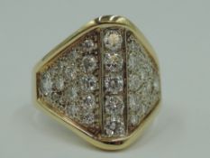 A diamond dress ring having approx 2ct of diamonds in an oversized pave set ridged mount on a yellow