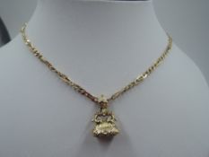 A 9ct gold fancy link figaro chain with yellow metal decorative fob, approx 22' and GW approx 20.8g