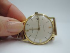 A gents Marvin automatic 18ct gold wrist watch,no:90837, having a baton numeral dial with date