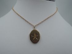 A 9ct gold oval locket having brushed finish with cut star decoration to front, on a 9ct gold