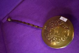 A vintage embossed brass chestnut roaster.