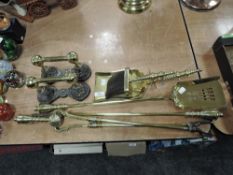 A selection of vintage brass fireside items including brush, shovel and poker.
