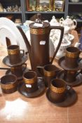 A vintage Portmeirion part coffee set having brown ground and gilt Greek key pattern.