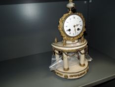 An antique Ormolu mantel clock,having roman numerals and numbers to enamel face and bevelled glass