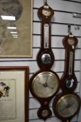 An antique banjo style barometer having a mahogany case with bulls eye mirror