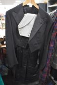 A gents vintage black tailcoat with grey waistcoat, around 1950s.
