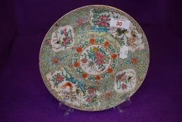 A well decorated Chinese plate in a Cantonese palette